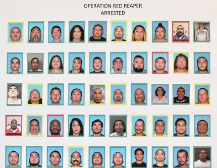 Law enforcement officials displayed a poster highlighting arrests made during the major operation on Tuesday.